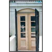 Paired divided light cypress doors. Double insulated glass was salvaged from discarded windows.