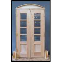 Paired divided light cypress doors. Double insulated glass was salvaged from discarded windows.